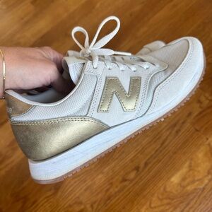 Rare Women’s New Balance 574 gold sneaker (size 8 US)